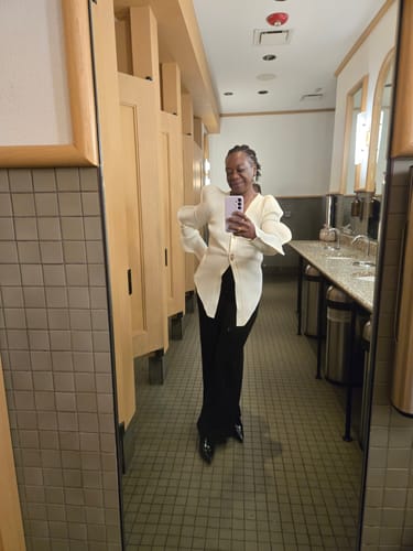 Reviewer shows the fit of the Wave Sleeve V-Neck Knitted Cardigan with black pants in a mirror selfie.
