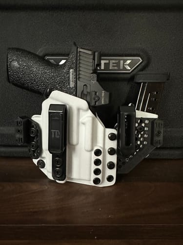 Customer's white APX holster holding a black handgun and an extra magazine.