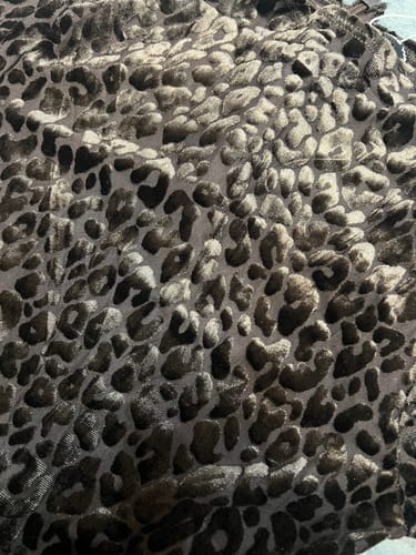 Customer's close-up of the Burnout Closed Toe Jumpsuit's velvety, animal-print material.