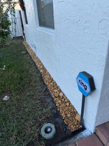Customer's Brown River Rock XL used as a decorative border along the foundation of a house.