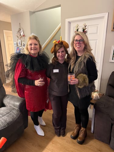 Reviewer and two other guests in festive costumes for the Christmas Murder Mystery Dinner Party Game.