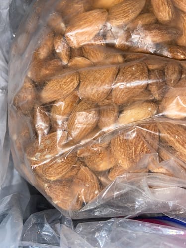 Customer's close-up view of Raw Almonds in a large, clear plastic bag.