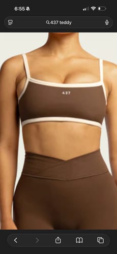 Reviewer showing the fit of the brown Micro Bra with cream contrasting straps and matching V-waist leggings.