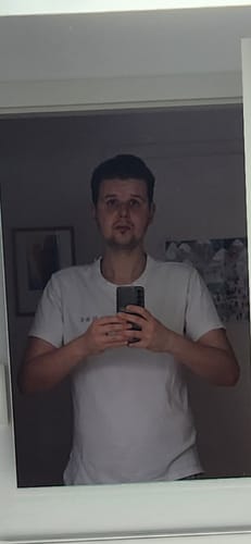 Reviewer's mirror selfie showing their face after using the Essentials skincare products.