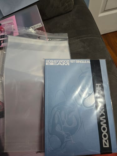 Reviewer showing a premium album sleeve protecting a light blue K-pop album.