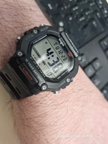 Reseñador mostrando su reloj Casio Vintage negro en la muñeca, con la pantalla digital de números grandes encendida.