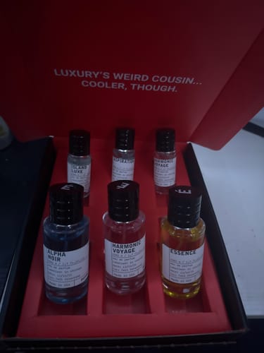 Reviewer's set of six perfume bottles displayed in an open red presentation box.