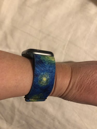 A close-up of a customer wearing the vibrant Starry Night Watch Band on their wrist.