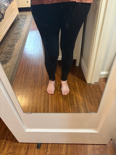 Reviewer wearing the black Stella Leggings, showing the full length and sleek fit from the front.