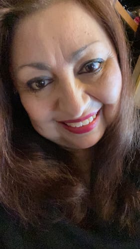 Close-up of a reviewer's face, showing her complexion in a review for Grass Fed Tallow & Honey Balm.