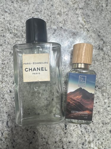 Reviewer's bottle of Scottish Highlands perfume next to a bottle of Chanel Paris-Édimbourg for comparison.