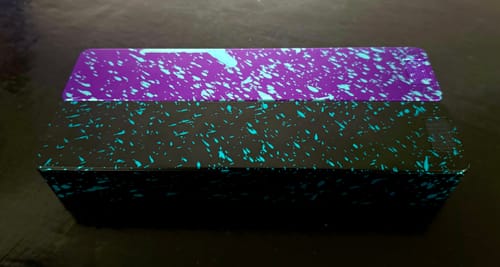 Customer's two-piece Weekly AM-PM Vitamin XL Case with a black and purple splatter-paint design.