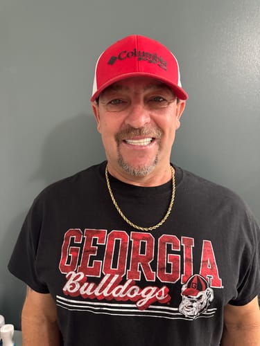 Customer smiling, showing off a bright, white smile with his Pop On Veneers.