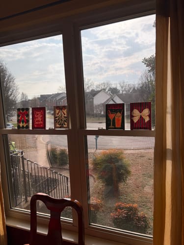 Customer's five completed mini paintings from the Merry Christmas Set displayed on a sunny windowsill.