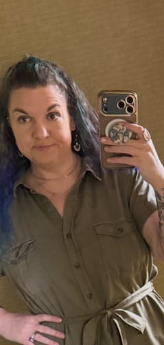 Reviewer wearing a layered necklace and drop earrings from the WaterProof Jewelry Bundle in a mirror selfie.