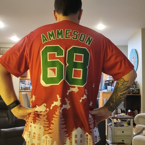 Reviewer from behind wearing a custom red Christmas jersey with the name 'Ammeson' and the number '68' in green and white.