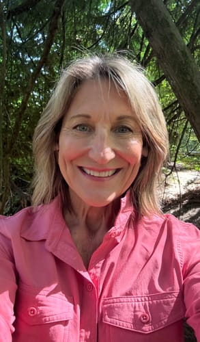 Reviewer smiling outdoors with smooth, natural lips, in a photo for LA LA LIPS LIP BALMS.