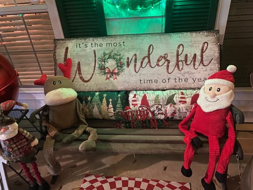 Reviewer's festive canvas sign reading 'it's the most Wonderful time of the year' displayed on a decorated porch bench.