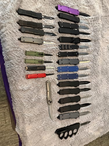 Customer's collection of various Viper Tec knives, including the VT Mini Missile OTF, laid out on a grey surface.