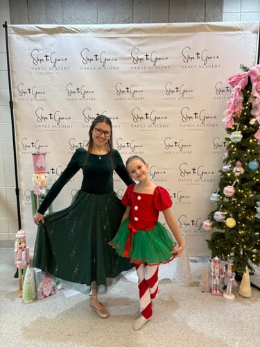 Reviewer in the gorgeous green Velour Ballerina Dress, posing at a holiday event.
