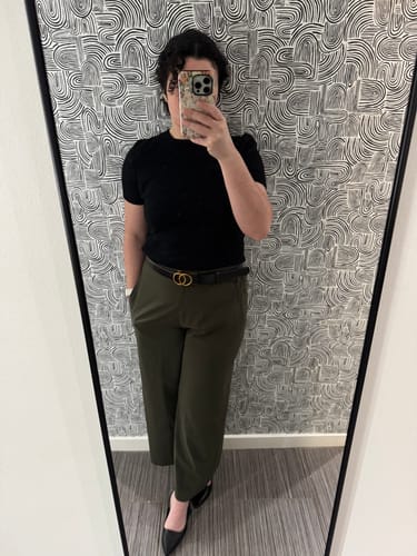 Reviewer showing a full-length view of the olive Elena Travel Culottes paired with a black top and belt.