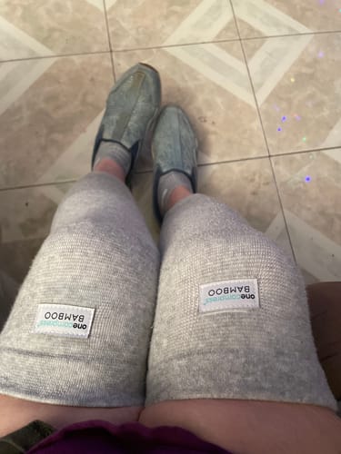 Customer wearing two light gray Premium Bamboo Knee Sleeves on their legs.