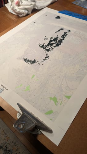 Reviewer's in-progress Grumpy Cat Paint by Number canvas, clipped to a board and partially painted.