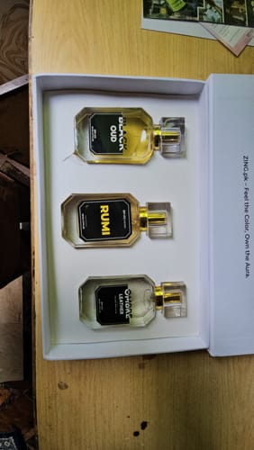Customer's OUD perfume bundle displaying three bottles—Black Oud, Rumi, and Ombre Leather—in a white presentation box.