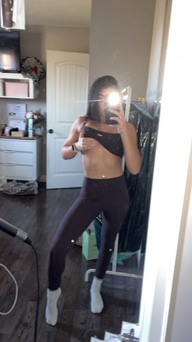 Reviewer takes a mirror selfie showing the full-length fit of the high-waisted Essentials Legging in Espresso.