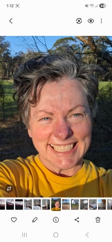 Customer smiling outdoors showing her clear, healthy-looking skin after using the Sea Buckthorn Serum.