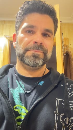 Reviewer wearing their black Legacy Necklace with several steel beads.