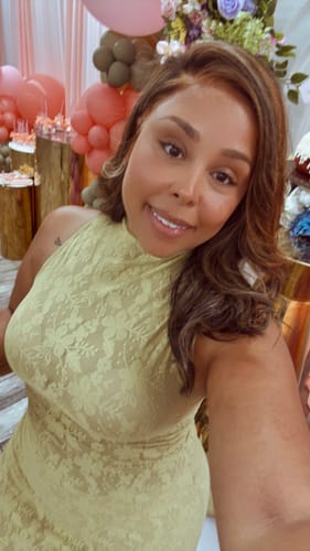 Close-up of a reviewer in the light green Stretch Lace Sleeveless Maxi Dress, showing the neckline and lace detail.
