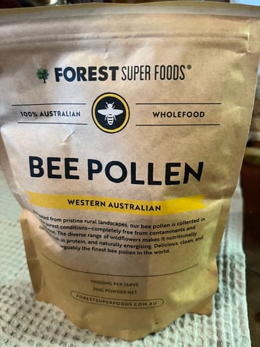 Customer's pouch of Forest Super Foods West Australian Bee Pollen standing on a textured counter.