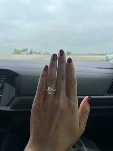Customer wearing the sparkling Harper Deluxe | Oval engagement ring on their hand.