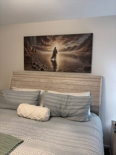 Customer's 'Walking on Water - Faith Wall Art II' hanging above a light wood bedframe in a cozy bedroom.