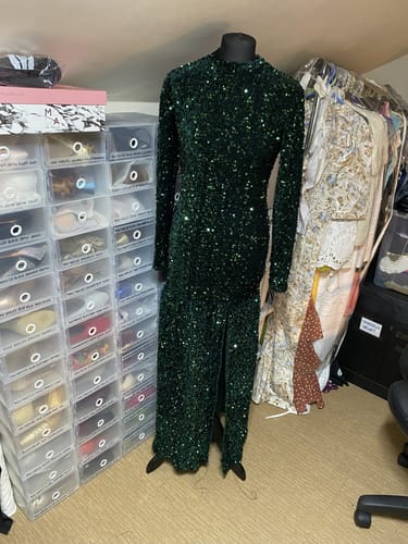 Reviewer's finished emerald green sequin dress made from the fabric, shown on a mannequin.