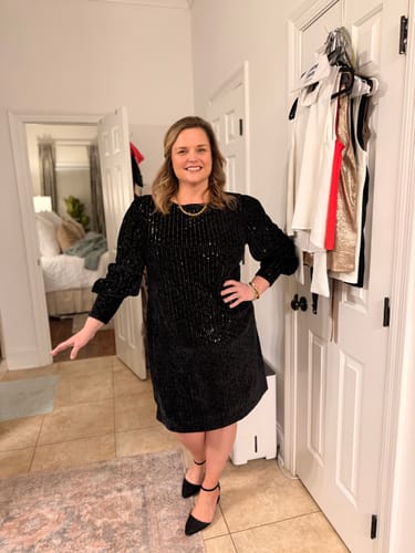 Reviewer smiling while wearing the gold Coco Rope Necklace with a black sequined dress for a wedding.