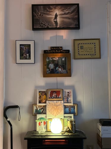 Customer's 'Walking on Water' wall art hanging in a living room above a collection of other framed photos.