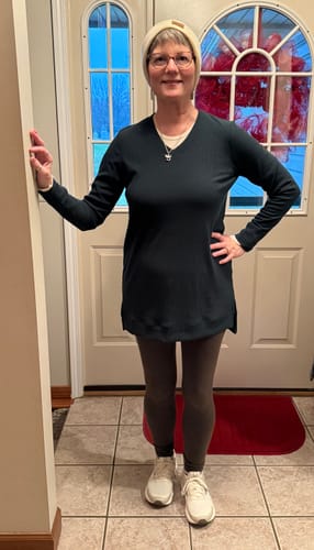 Customer wearing the Evie Ribbed Tunic in Deep Timber with leggings and a beanie, showing its length.