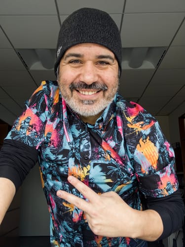 Reviewer smiling while wearing the vibrant Star Wars™ "Dark Side Rising" shirt over a black long-sleeve top.