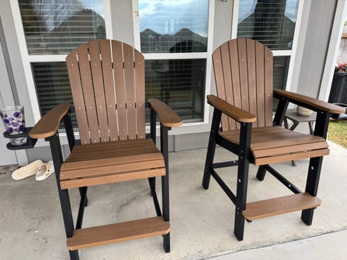 Customer's two brown and black Counter Height Bistro Tete-a-tete chairs set up on a patio.