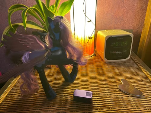 Customer's purple Nano Case on a nightstand, shown next to a matching My Little Pony figurine.