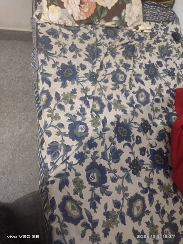 Customer's Flo Mattress Ortho on a bed, covered with a floral patterned bedsheet showing the perfect fit.