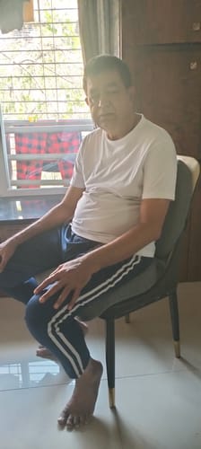 Customer sitting on a chair in a room while using the Frido Ultimate Pro Seating Combo.
