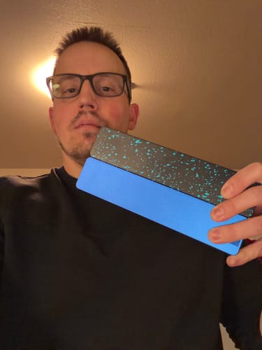 Customer holding the blue and speckled black Weekly AM-PM Vitamin XL Case 2.0.