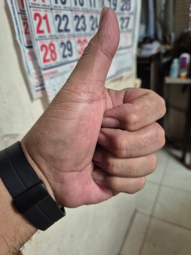 Reviewer gives a thumbs-up gesture, expressing satisfaction with the Nike Men's Free 2025 Workout Shoes.