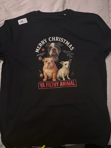 Customer's black t-shirt with a Christmas graphic of three dogs and text 'Merry Christmas Ya Filthy Animal'.