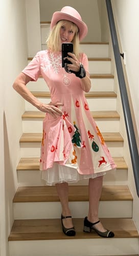 Reviewer lifts her pink dress to reveal the white petticoat underskirt, adding volume.