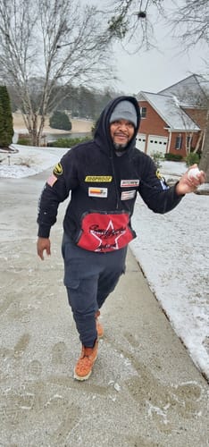 Customer who purchased the Fast Pass - Bronze, smiling and holding a snowball in a snowy scene.