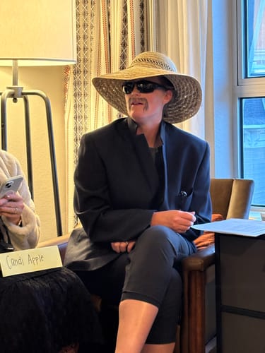 Reviewer in costume with a hat and mustache playing a character from the Bake Off Themed Murder Mystery Game Kit.